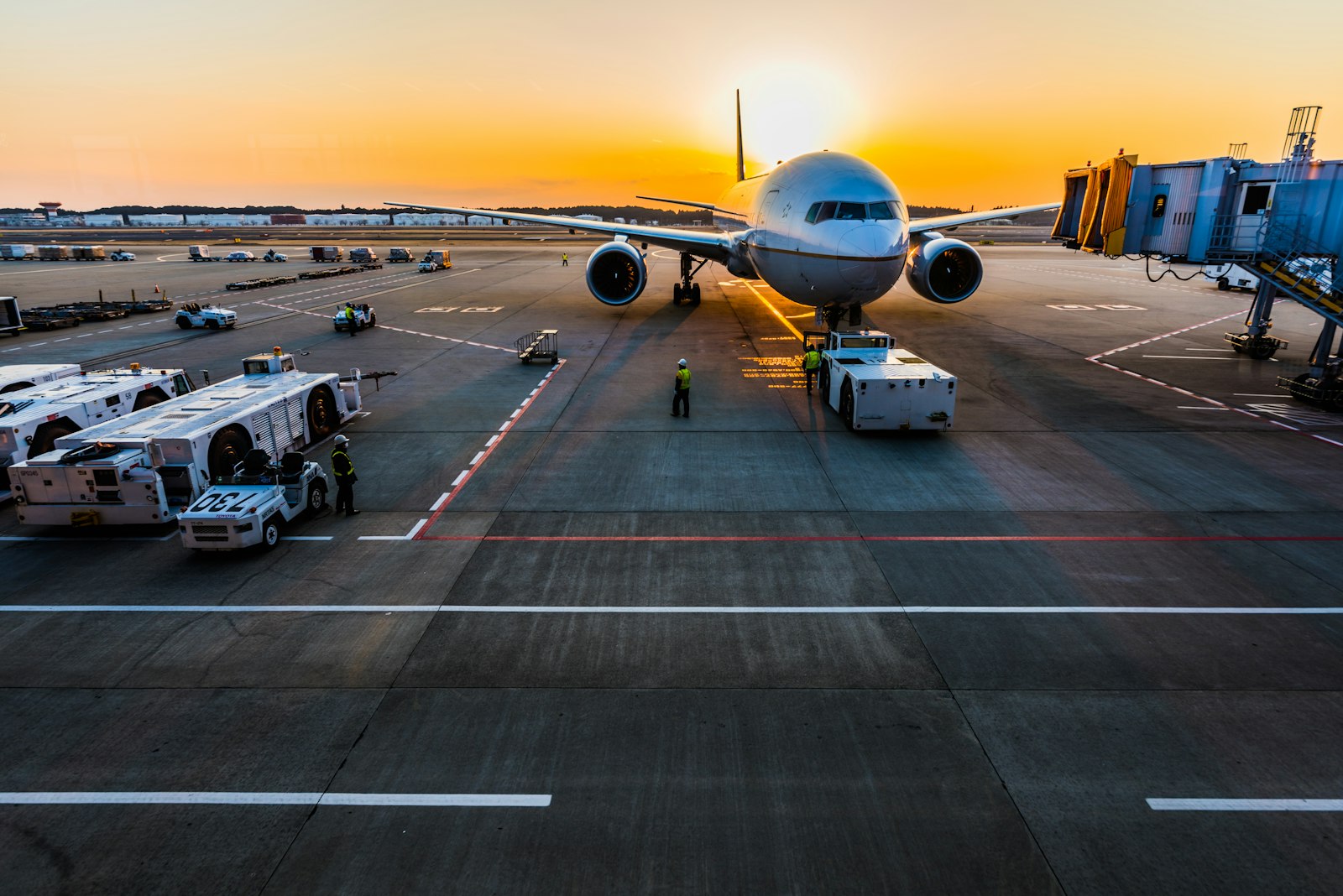 Wide-body aircraft at an airport gate at dusk